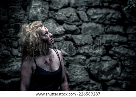Zombie woman in an abandoned house searching for her victims
