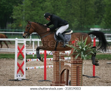 MOSCOW - MAY 16: Rider on his horse  jumps over the barrier in CSKA Summer Showjumping Cup event May 16, 2009 in Moscow, Russia