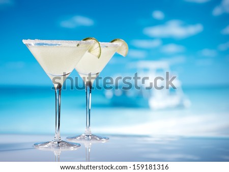 margarita  cocktail on beach, blue sea and sky background