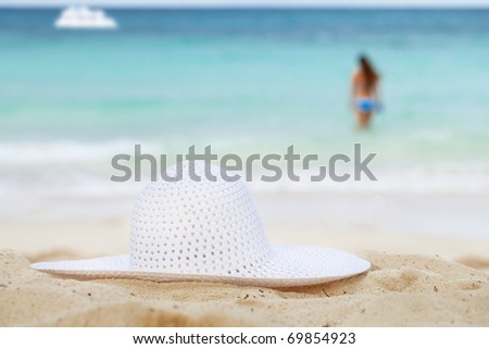 sea, beach, white hat,  girl  and boat.  shallow dof