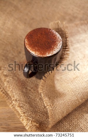 hot frothy drink cappuccino chocolate dusted, rustic style, shallow dof