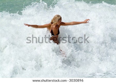 Youing woman play in waves