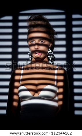 Silhouette of elegant fashion woman - striped window