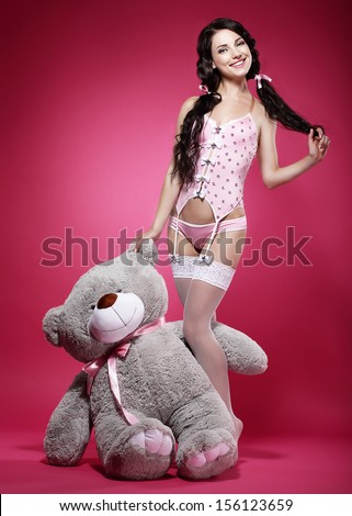 Birthday. Playful Young Enticing Woman holding her Gift - Teddy Bear