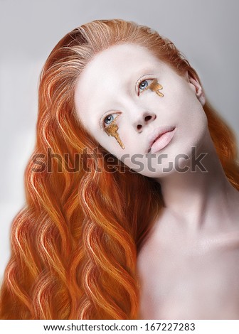 Harlequin. Artistic Red Hair Woman with Painted Face and Creative Makeup