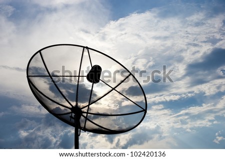 black antenna communication satellite dish over cloudy sky