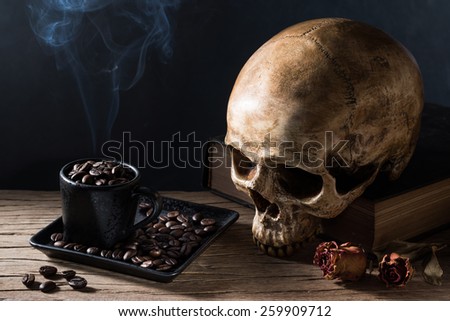 still life photography : human skull with coffee bean in cup with a smoke in hot hell coffee concept
