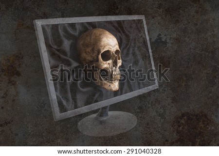 mix up of skull on black fabric and old computer monitor on grunge background in computer virus warning concept