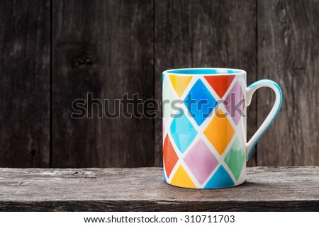 colorful mug on old wood plank with old wood background