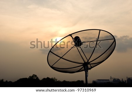 black antenna communication satellite dish over sunset sky