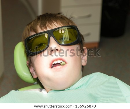Boy waiting for laser treatment in dental office