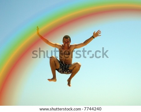 happy man jumping over rainbow