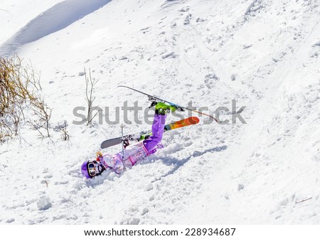 Accident at the ski resort. Little girl falls in soft snow off piste
