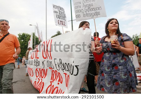GREECE, Thessaloniki JUNE 29, 2015: Supporters of the NO vote in the upcoming referendum protest while holding banners reading NO (OXI in greek) during a rally around the White Tower in Thessaloniki