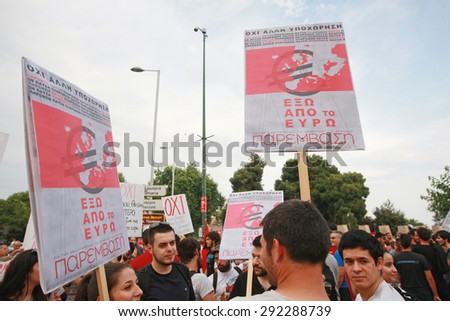GREECE, Thessaloniki JUNE 29, 2015: Supporters of the NO vote in the upcoming referendum protest holding banners reading OUT OF EURO during a rally around the White Tower in Thessaloniki