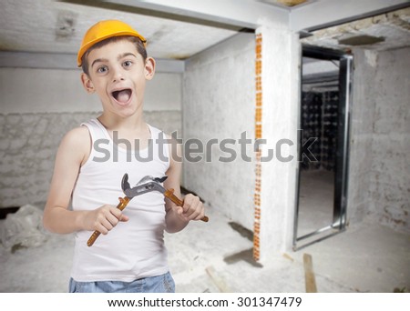 Little construction worker on a construction site background. Image with shallow depth of field.