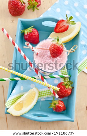 Milk shake with fresh strawberries with colorful straws