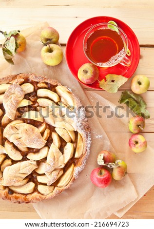 Homemade apple pie made with fresh organic apples and a cup of tea