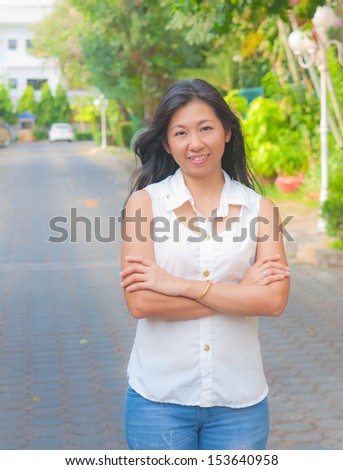 Portrait of an Asian woman chill out on a street