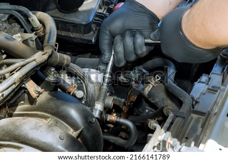 Auto mechanic replacement and installing a new throttle body on the engine ストックフォト © 