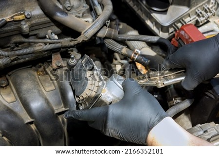 Mechanic in process replacement throttle body of car engine for repair car service ストックフォト © 