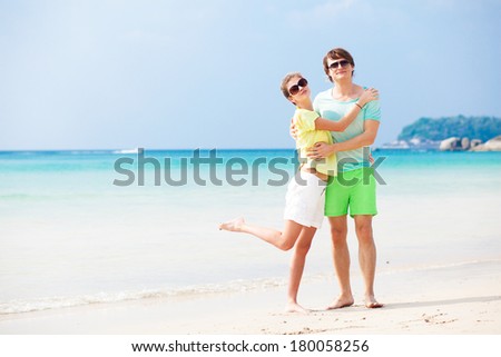 Couple in bright clothes on tropical beach in Thailand