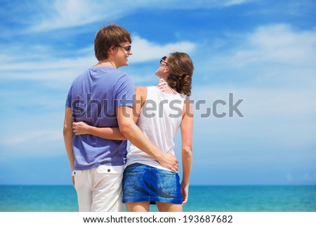 back view of young couple at beach