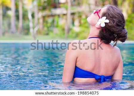 back view of fit woman in luxury spa pool