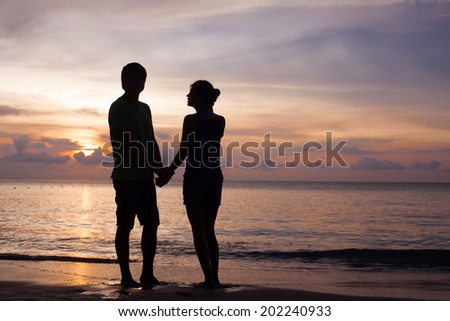silhouette of two people in love at sunset