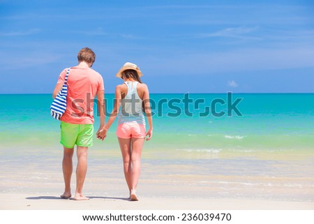 back view of couple hugging on a tropical beach at Maldives