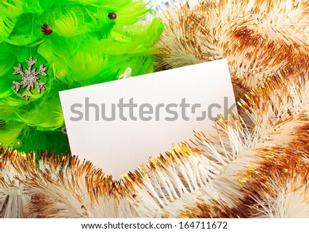 green christmas tree made of feathers with greeting cards