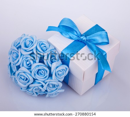 blue flowers and white gift box with blue ribbon