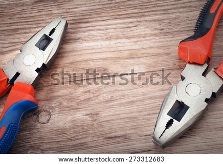 combination cutting pliers on wooden  background