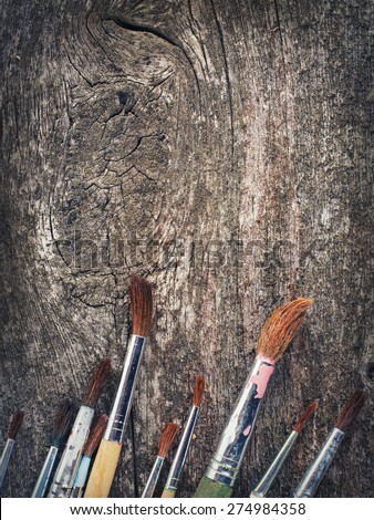 brushes for painting  on vintage wooden  background copy spece