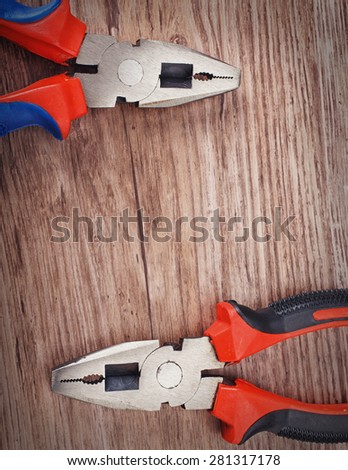 combination cutting pliers on wooden  background, copy space