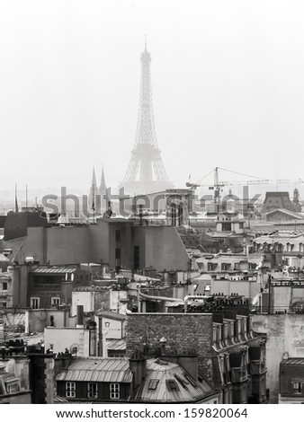 Paris, on March 30, 2011. Roofs of Paris and Eiffel Tower. The black-and-white image in style of a retro