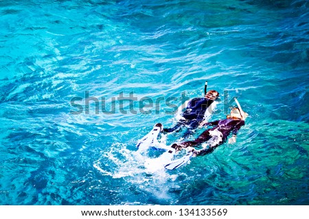 Couple skorkelling on the Great Barrier Reef, Australia
