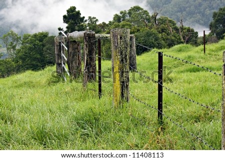 Farm fence on misty mountain