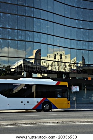 Public bus in front of a modern building