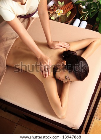 Woman in a day spa getting a deep tissue massage.