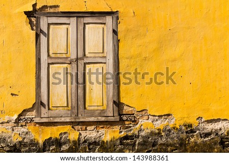Vintage windows on old yellow brick wall