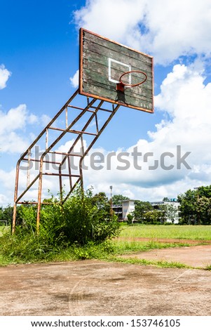 Old basketball hoop and wooden board on blue sky background