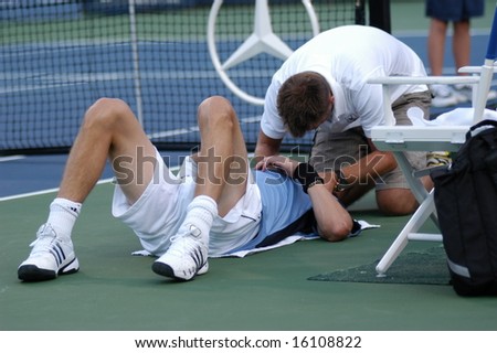 WASHINGTON, D.C. - AUGUST 12, 2008:  Marat Safin (RUS) is treated for during his match against Fabio Fognini (ITA) at the Legg Mason Tennis Classic.  Safin later withdrew due to a neck injury.