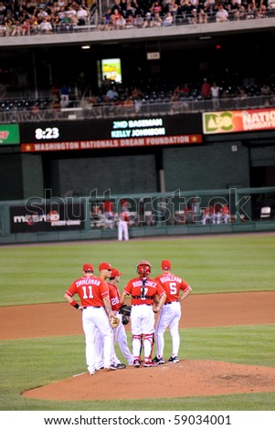 WASHINGTON - AUGUST 14: Washington Nationals players confer on the pitcher\'s mound at their home game against the Arizona Diamondbacks on August 14, 2010 in Washington.