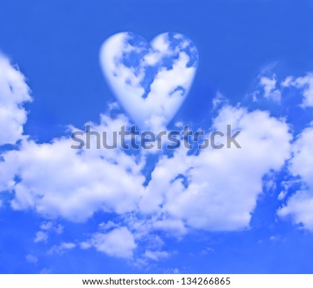 A heart of clouds floating atop other clouds in a bright blue sky.