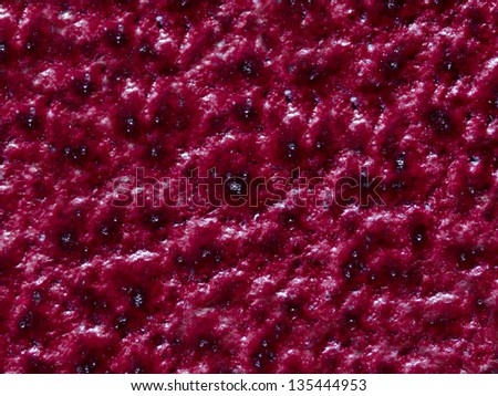 A close up image of a red, wild berry jam for use as a pattern or background.