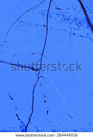 A close up of a cracked blue stone wall material for use as a background or texture