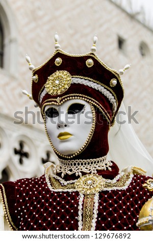 VENICE, ITALY - FEBRUARY 10: Unidentified person with traditional Venetian carnival mask in Venice, Italy at February 10, 2013. At 2013 it is held from January 26th to February 12th.