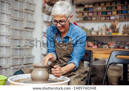 Similar – Image, Stock Photo Ceramist hands make a plate of clay