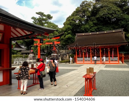 KYOTO, JAPAN - AUGUST 21: Unidentified people at Fushimi Inari taisha shrine in Kyoto, Japan at August 21, 2013. This popular shrine is said to have as many as 32,000 sub-shrines throughout Japan